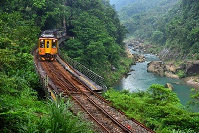new taipei, taiwan, next to the valley, the train through the tunnel in the mountains, is a beautiful scene.