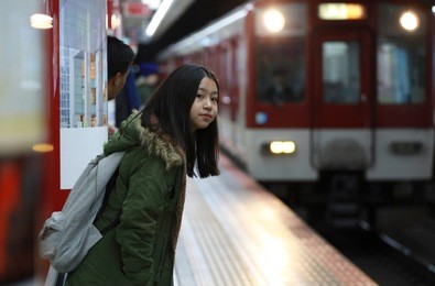 young girl waiting underground train at station,japan