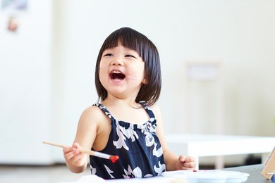 lovely little girl painting in home