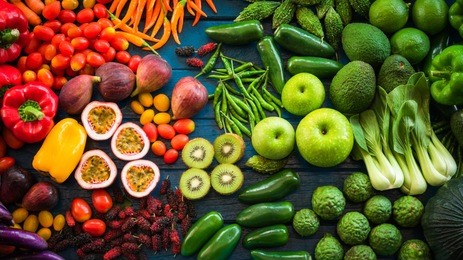 flat lay of fresh  fruits and vegetables for background, different fruits and vegetables for eating healthy, colorful fruits and vegetables on blue plank background