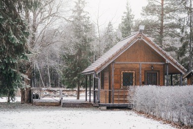 small wooden camping house in forest 