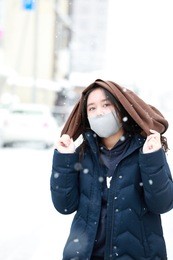 girl teenage on the snow day enjoying herself on a cold winter day in japan