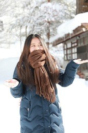 girl teenage on the snow day enjoying herself on a cold winter day in japan