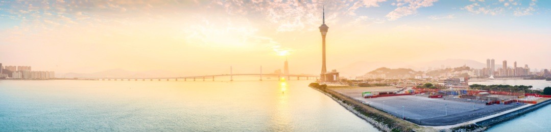landscape of macau at dusk. in the distance is macau tower and sai van bridge (ponte de sai van). taken from macau-taipa bridge (aodang bridge). located in macau.