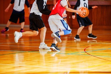 middle school student playing basketball game