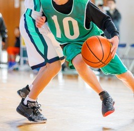 middle school student playing basketball game