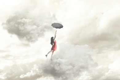 surreal moment of an elegant woman flying in the middle of the clouds hanging on her umbrella