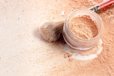 close-up of crushed mineral shimmer powder golden color with makeup brush