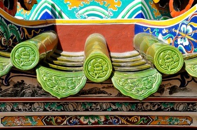 close up end view of green cylindrical roof tiles in a traditional chinese temple