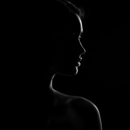 silhouette of beautiful young woman isolated on black background