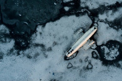 aerial view of united states navy dc plane wreck on the black beach at sólheimasandur, in the south coast of iceland.