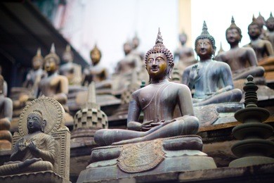 famous siting buddha statues in the seema malaka temple - gangaramaya in colombo