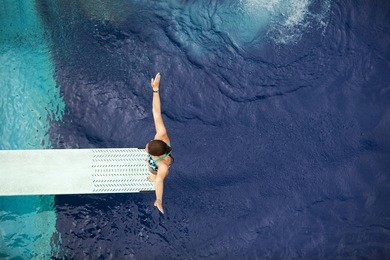 girl standing on diving board