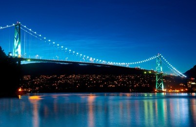 the lion's gate bridge in vancouver, british columbia during an evening blue hour.
