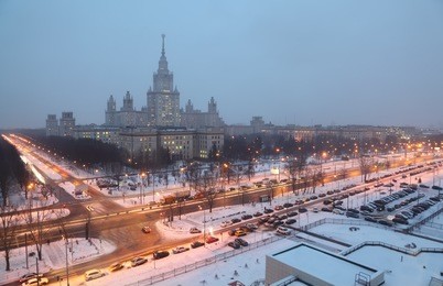 main building of moscow state university at night winter in moscow, russia, view through window