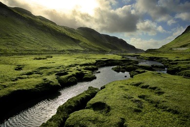 spring in scotland valley: infectious greens, winding streams, and volatile skies -- all typical of spring in scotland.  taken on isle of skye, in the scottish highlands.