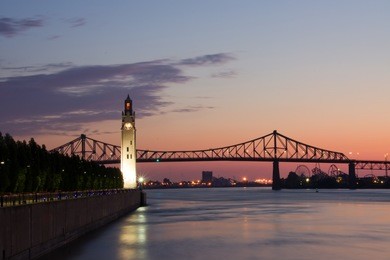 st. lawrence river with big ben in old montreal, and jacques-cartier bridge in background, with a beautiful sunrise.
