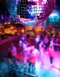 people dancing under colorful lights of disco mirror ball