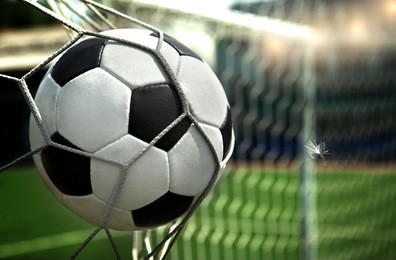 football. the ball flies into the net gate