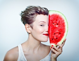 young beauty woman holding watermelon in her hand