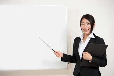 asian teacher with blank whiteboard