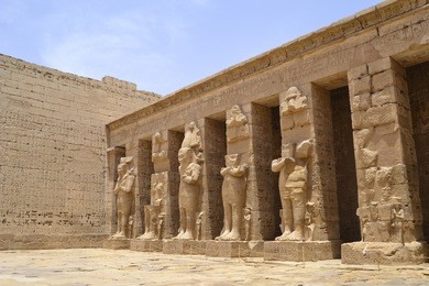 hieroglyphic carvings in the walls at medinat habu temple at luxor