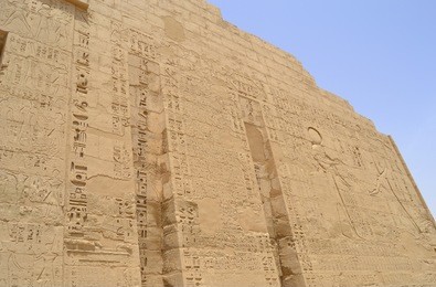 hieroglyphic carvings in the walls at medinat habu temple at luxor