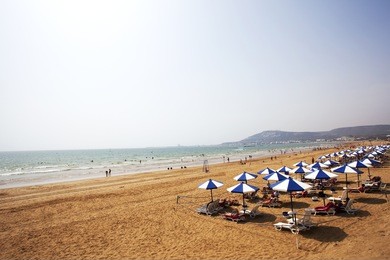 straw beach umbrella with blue sky