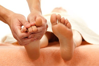 massage foot female close-up isolated on white background