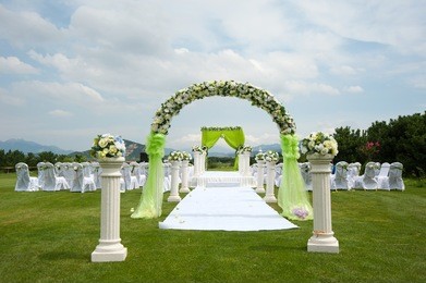 beautiful wedding flower arrangement of seats along the aisle