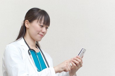 asian woman doctor using smart phone