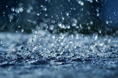 view of falling rain cast in a blue light.