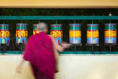 tibetan buddhist monk (lama) and prayer wheels