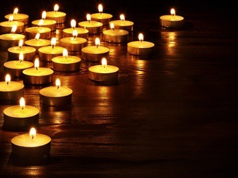 group of burning candles on  black background.