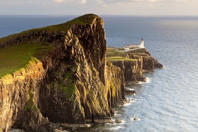sunset and lighthouse at neist point, isle of skye, scotland, uk