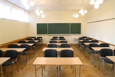 traditional classroom interior with blackboard and desks