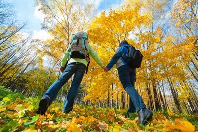 young couple with backpacks in the park. fall.