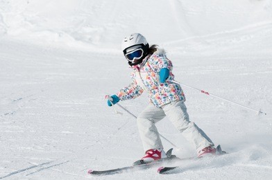 skiing - little skier skiing on ski slope