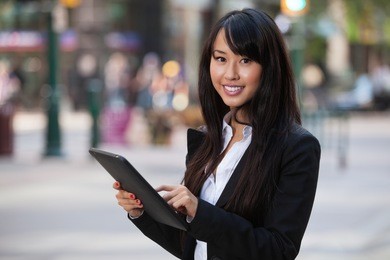 portrait of smiling business woman using tablet pc