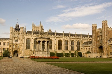 view of the impressive great court at trinity college, university of cambridge.  including the fountain, the great gate and clock tower.  the film chariots of fire was partly set here.