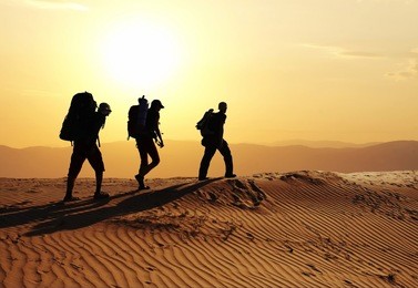 group go up in sand desert