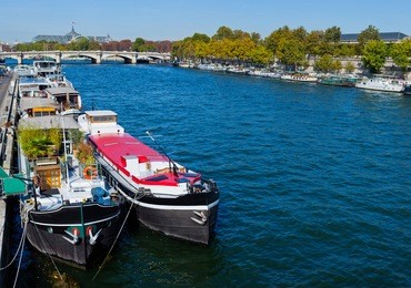 view of a two living barge on the seine in paris. france
