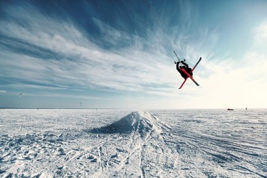 ski kiting and jumping on a frozen lake