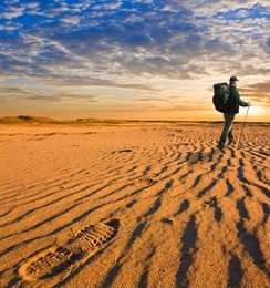 hiker walk in a hot sand desert