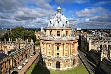 the landmark radcliffe camera reading room of the university's bodleian library in central oxford, england, surrounded by the spires of historic colleges