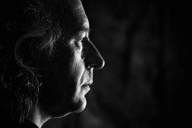 black and white profile portrait of older white male with side lighting.