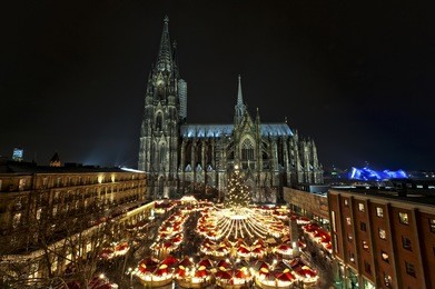 overview over the christmasmarket with the cologne cathedral. part of the unesco worldheritage. the most visited object of interest in germany is 157.38 m tall.