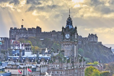 edinburgh castle and balmoral clock tower at dusk, scotland