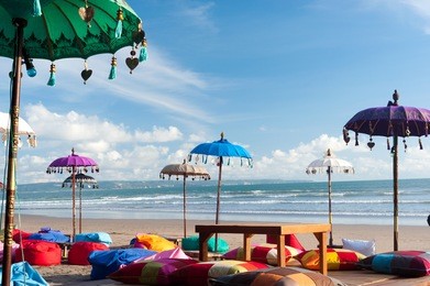 colorful beach umbrellas and pillows in kuta, bali