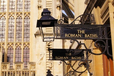 iron signs for the roman baths of bath england in front of the abbey